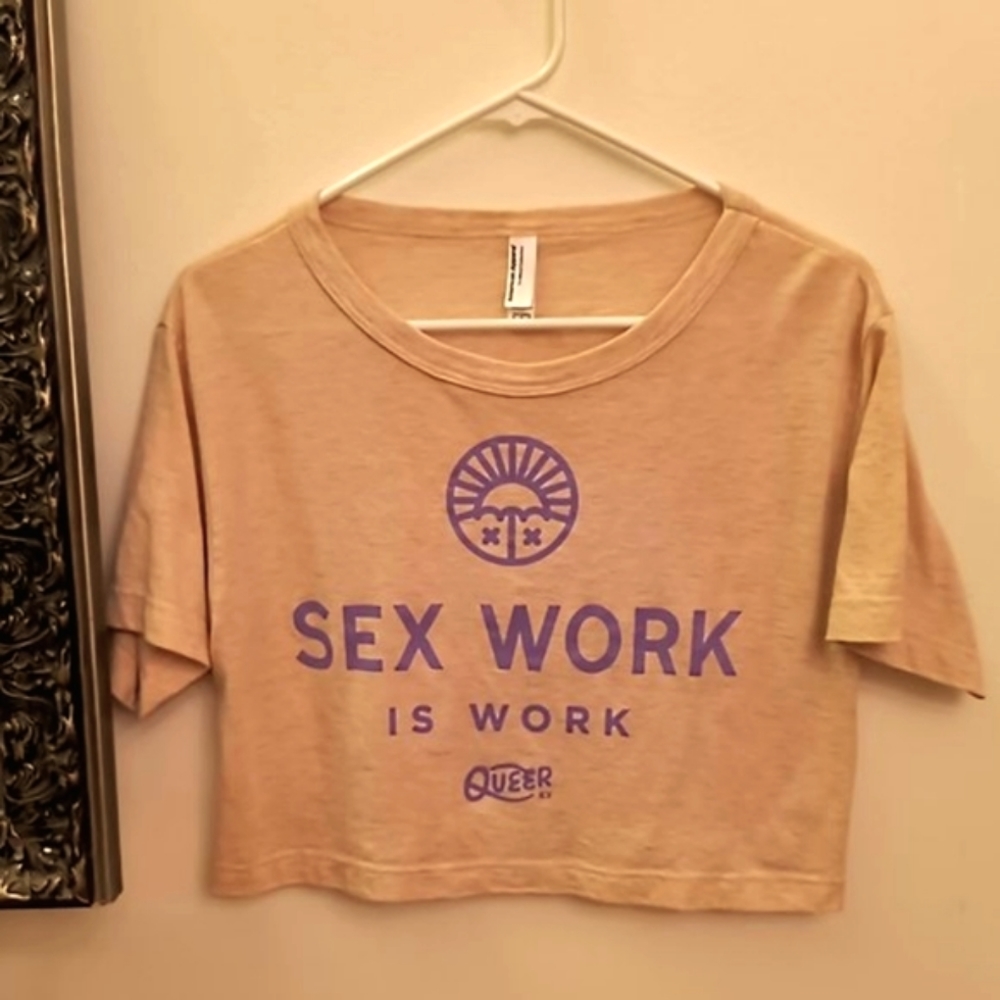 Pink and purple "sex work is work" crop top